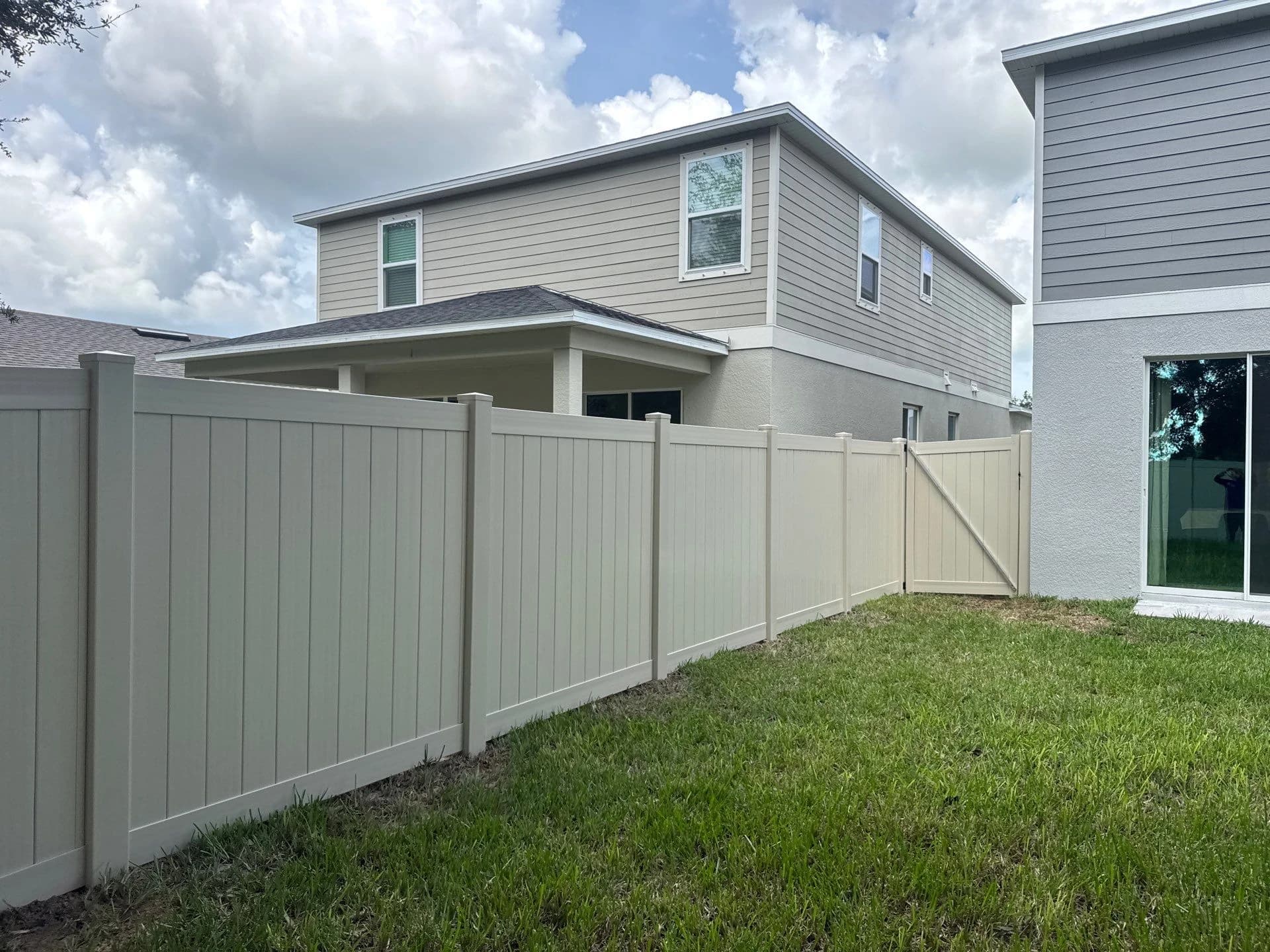 Completed ASAP tan vinyl privacy fence and gate in Palmetto